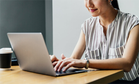 Woman working on laptop at table